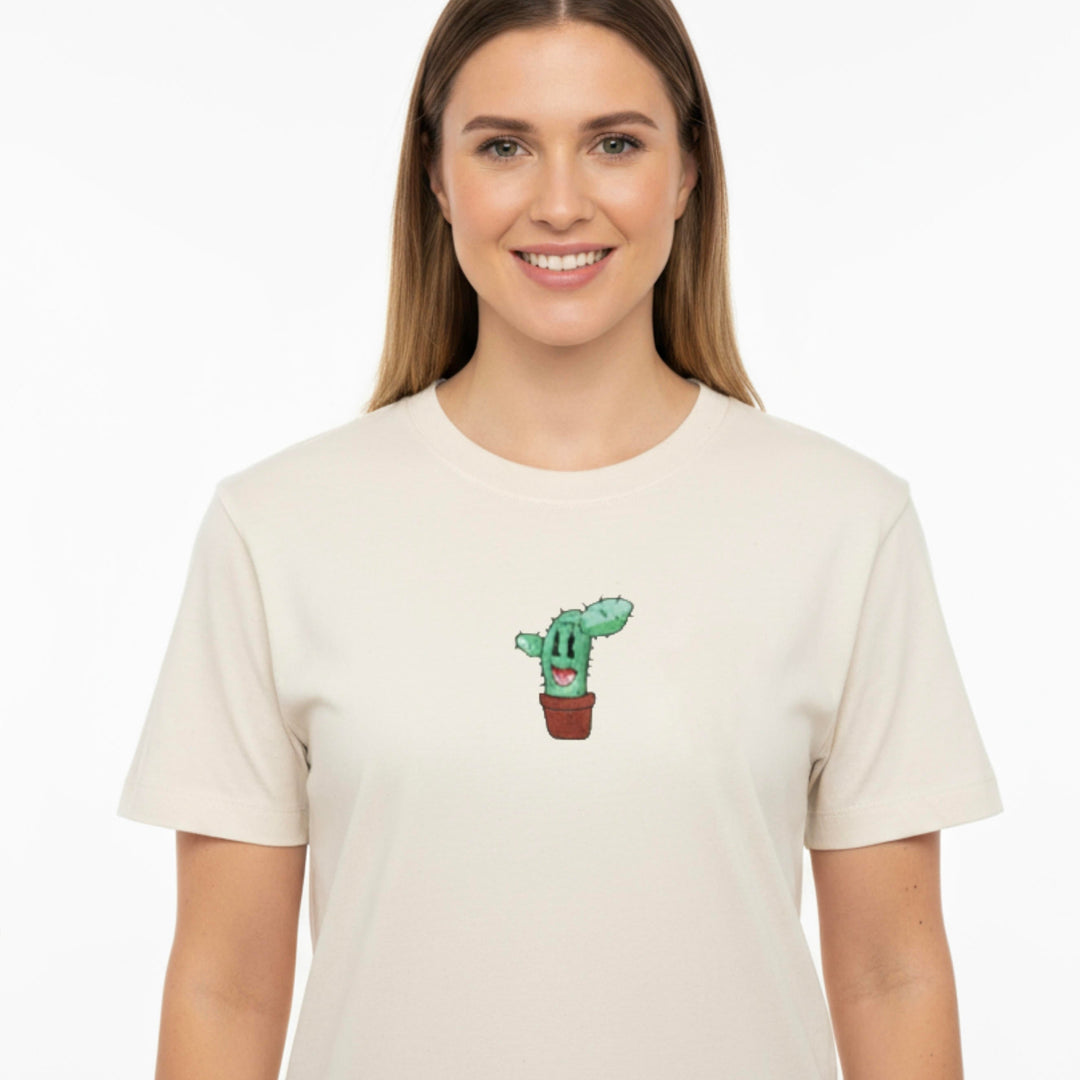 Woman wearing a beige t-shirt with a cactus design on a white background