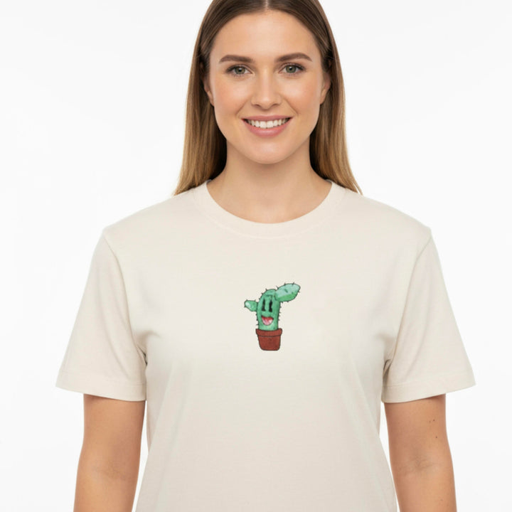 Woman wearing a beige t-shirt with a cactus design on a white background