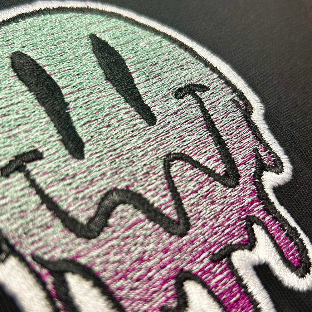 Embroidered patch with a colorful design on a black tee