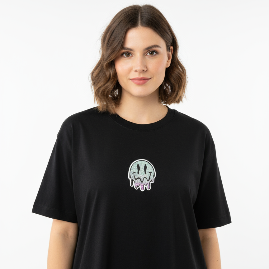 Person wearing a black t-shirt with a small graphic design on a white background