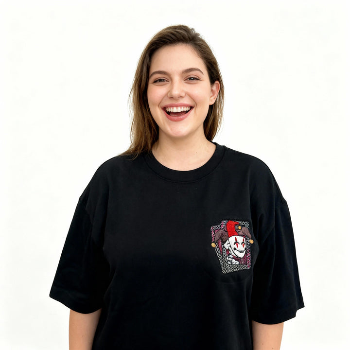 Woman wearing a black t-shirt with a colorful graphic on a white background