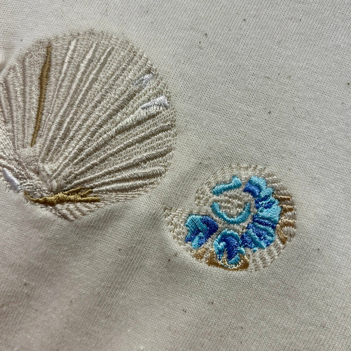 Embroidered shell and floral design on organic cotton tee