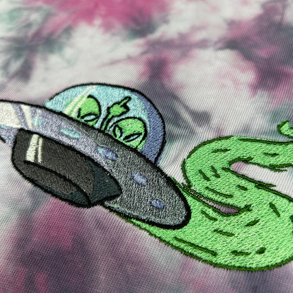 Embroidered design of a snake and a shoe on a tie-dye background