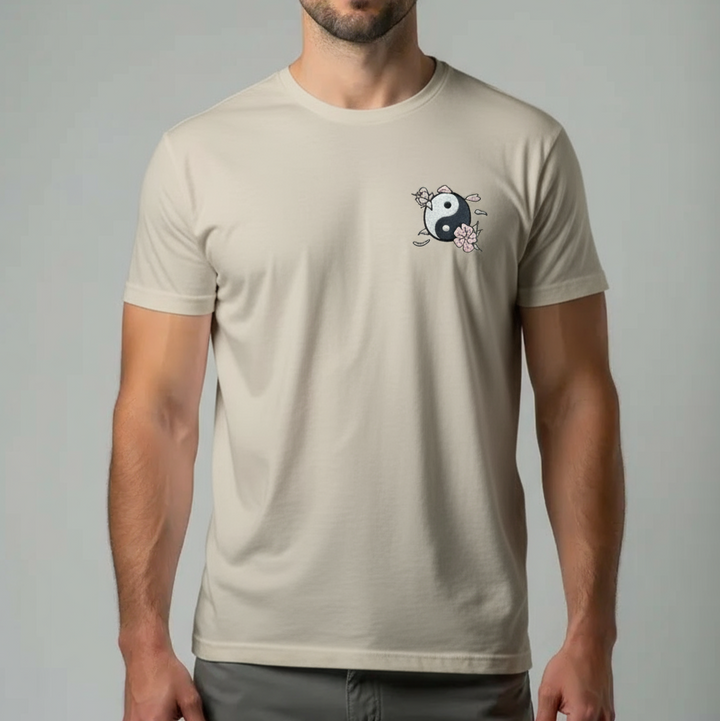 Man wearing a beige t-shirt with a logo on a gray background